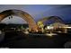 Entryway to the community, featuring manicured landscaping, lighting and an arched entryway at 8510 S 9Th Dr # 20, Phoenix, AZ 85041