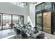 Modern dining room features a glass table, plush seating, and expansive windows providing natural light at 8510 S 9Th Dr # 20, Phoenix, AZ 85041