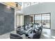 Elegant dining area featuring a glass table, soft gray seating, high ceilings, and modern design elements at 8510 S 9Th Dr # 20, Phoenix, AZ 85041