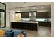 Modern kitchen with a large island, dark cabinetry and high-end appliances at 8510 S 9Th Dr # 20, Phoenix, AZ 85041