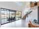 Bright living room features high ceilings, black framed windows, and stairs to the upper level at 8510 S 9Th Dr # 20, Phoenix, AZ 85041