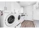 Well-lit laundry room features modern white cabinets and a washer and dryer at 8514 S 9Th Dr # 21, Phoenix, AZ 85041