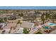 Expansive aerial view showcasing the home, landscaped yard, pool, and neighborhood amenities at 8554 W Keim Dr, Glendale, AZ 85305