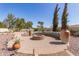 Inviting backyard features a circular brick patio with a fire pit and decorative flower mural bench at 8554 W Keim Dr, Glendale, AZ 85305