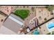 Aerial view of a spacious landscaped backyard featuring a pool, fire pit, grass area, and outdoor kitchen at 8554 W Keim Dr, Glendale, AZ 85305