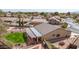 Aerial view highlighting a backyard with a fire pit, a green lawn, desert landscaping, and a patio at 8554 W Keim Dr, Glendale, AZ 85305