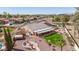 Aerial image showcasing a backyard with a fire pit, patio, and view of the neighborhood and stadium at 8554 W Keim Dr, Glendale, AZ 85305