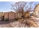 Backyard with a storage shed and a mature tree with a brick walkway at 8554 W Keim Dr, Glendale, AZ 85305