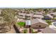 Aerial shot of a backyard with a green lawn, patio, fire pit, and a view of surrounding neighborhood homes at 8554 W Keim Dr, Glendale, AZ 85305