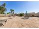 Spacious backyard featuring desert landscaping with a hammock, lounge chairs, and seating area at 8554 W Keim Dr, Glendale, AZ 85305