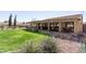 Inviting covered patio area with ample seating, overlooking a lush green lawn and mature landscaping at 8554 W Keim Dr, Glendale, AZ 85305