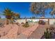 Backyard featuring a vibrant desert mural, red brick path, lush cactus garden, and covered patio table at 8554 W Keim Dr, Glendale, AZ 85305