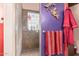 Shower stall with tiled walls and floor, accented by decorative wall hangings and colorful towels at 8554 W Keim Dr, Glendale, AZ 85305