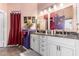 Bright bathroom features double sinks, granite countertops, and plenty of cabinet space at 8554 W Keim Dr, Glendale, AZ 85305
