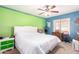Bright bedroom with green and blue accents, featuring a cozy bed and ample natural light at 8554 W Keim Dr, Glendale, AZ 85305