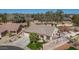 Aerial view of a single-story home boasting a well-maintained yard with mature trees and desert landscaping at 8554 W Keim Dr, Glendale, AZ 85305