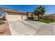 Beautiful house with a three-car garage and a well-manicured lawn, showcasing desert landscaping at 8554 W Keim Dr, Glendale, AZ 85305