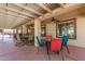 Covered patio with ceiling fans, a pergola and multiple seating areas for outdoor entertaining at 8554 W Keim Dr, Glendale, AZ 85305