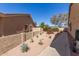 Desert-landscaped side yard featuring cacti, agave plants, and a rose bush at 8554 W Keim Dr, Glendale, AZ 85305