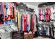 Organized walk-in closet featuring hanging clothes, shelves, and storage containers for optimal storage at 8554 W Keim Dr, Glendale, AZ 85305