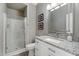 Bathroom with a shower featuring glass doors, a granite countertop, and neutral colored walls at 8813 S 51St St # 3, Phoenix, AZ 85044