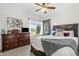 Bright bedroom featuring a ceiling fan, carpet, and a large window with a view of the green outdoors at 8813 S 51St St # 3, Phoenix, AZ 85044