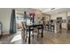 Open-concept dining area with a dark wood table and chairs, and kitchen access at 8813 S 51St St # 3, Phoenix, AZ 85044