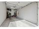 Interior of a clean two-car garage with organized storage shelves and tools on the left wall at 8813 S 51St St # 3, Phoenix, AZ 85044