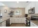 Modern kitchen with white cabinets, granite countertops, stainless steel appliances, and a window at 8813 S 51St St # 3, Phoenix, AZ 85044