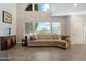 Inviting living room with high ceilings, large windows, and a comfortable tan sectional couch at 8813 S 51St St # 3, Phoenix, AZ 85044