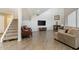 Cozy living room with gray wood floors, stairs, and a comfortable tan sectional couch at 8813 S 51St St # 3, Phoenix, AZ 85044