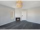 Cozy living room featuring a fireplace, modern light fixture, and sleek gray flooring at 9451 E Becker Ln # 2027, Scottsdale, AZ 85260