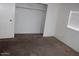 Empty bedroom with blinds, paneled walls and a built-in closet at 9501 E Broadway Rd # 237, Mesa, AZ 85208