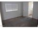 Carpeted bedroom with a bright window and attached bathroom at 9501 E Broadway Rd # 237, Mesa, AZ 85208