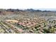 Expansive aerial view showcasing a community with tile roofs, surrounded by mountains and desert landscape at 10410 N Cave Creek Rd # 2034, Phoenix, AZ 85020