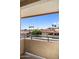 Balcony view overlooking rooftops, palm trees, and desert landscaping at 10410 N Cave Creek Rd # 2034, Phoenix, AZ 85020