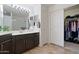 Bathroom featuring a walk-in closet, double sinks, and a tiled floor at 10410 N Cave Creek Rd # 2034, Phoenix, AZ 85020