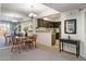 A dining room features a wood table and chairs, complemented by a mirrored wall and an adjacent kitchen area at 10410 N Cave Creek Rd # 2034, Phoenix, AZ 85020