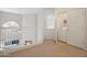 This carpeted hallway features a ceiling fan, white trim and a closet with a washer and dryer at 10410 N Cave Creek Rd # 2034, Phoenix, AZ 85020