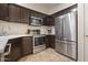 Well-equipped kitchen with stainless steel appliances and dark wood cabinetry at 10410 N Cave Creek Rd # 2034, Phoenix, AZ 85020