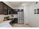 Modern kitchen with stainless steel appliances, dark wood cabinets, and light countertops at 10410 N Cave Creek Rd # 2034, Phoenix, AZ 85020