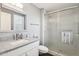 Modern bathroom featuring a glass-enclosed shower and a granite-topped vanity with a framed mirror at 10533 W Granada Dr, Sun City, AZ 85373