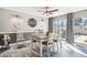 Dining room featuring hardwood floors, modern light fixtures and a sliding glass door at 10533 W Granada Dr, Sun City, AZ 85373