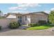 Beautiful landscaping with green lawn, decorative gravel and mature bushes surrounding the home at 10533 W Granada Dr, Sun City, AZ 85373