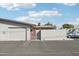 View of the garage and front entryway, plus a peek at the adjacent home at 10533 W Granada Dr, Sun City, AZ 85373