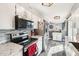 Well-lit kitchen with stainless steel appliances, white cabinetry, and a tile backsplash at 10533 W Granada Dr, Sun City, AZ 85373