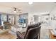 Inviting living room featuring a ceiling fan, and open floor plan with hardwood floors at 10533 W Granada Dr, Sun City, AZ 85373