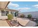 Charming backyard patio with mature plants, decorative rock features, and landscape lighting at 10533 W Granada Dr, Sun City, AZ 85373