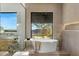 Bathroom with a modern soaking tub overlooking scenic views, and a walk-in shower at 11268 E Moonlight Cyn, Scottsdale, AZ 85255