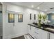 Bathroom featuring modern white cabinetry, marble counters, and a frameless glass shower at 11268 E Moonlight Cyn, Scottsdale, AZ 85255